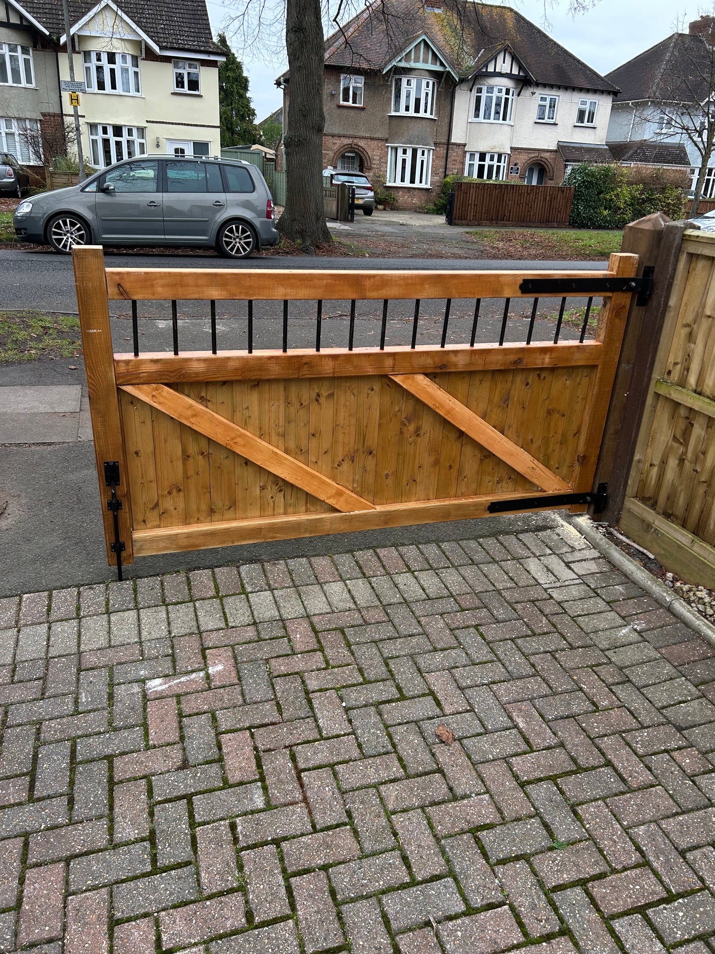 Wooden Garden and driveway gates with metal bar decoration