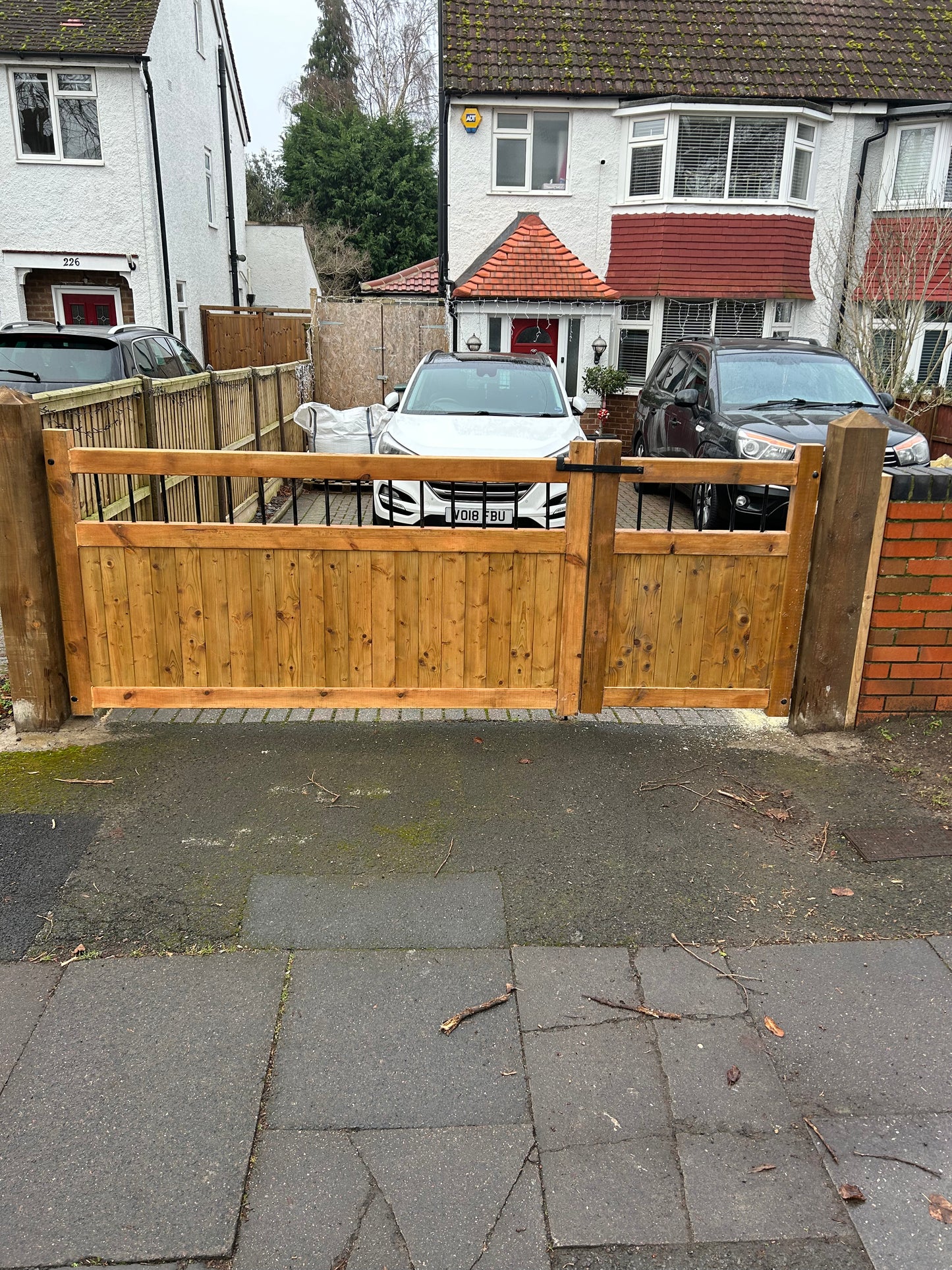 Wooden Garden and driveway gates with metal bar decoration